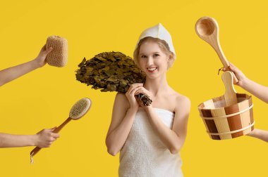 Sarı arka planda sauna malzemeleri olan keçeli şapkalı genç bir kadın.