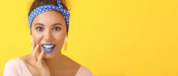 stock image Portrait of surprised fashionable young African-American woman on yellow background with space for text