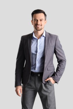 Handsome businessman in suit on light background