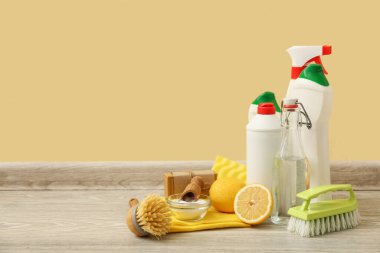 Ahşap masadaki fırçalı doğal temizlik malzemeleri seti.