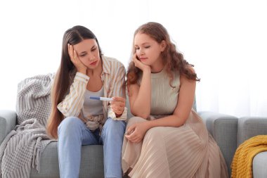 Evde hamilelik testi olan genç lezbiyen çift.