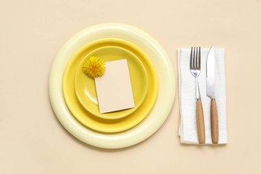 Beautiful table setting with dandelion flower on beige background
