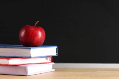 Elma ve kitaplar yazı tahtasının yanındaki masada. Okul konseptine dönelim.