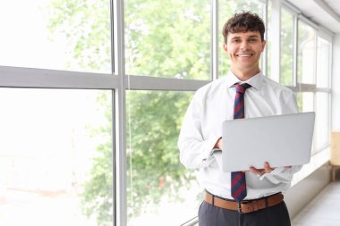 Ofiste dizüstü bilgisayar kullanan erkek muhasebeci.