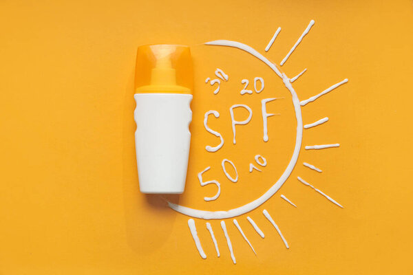 Composition with bottle of sunscreen, word SPF and numbers made of cream on color background