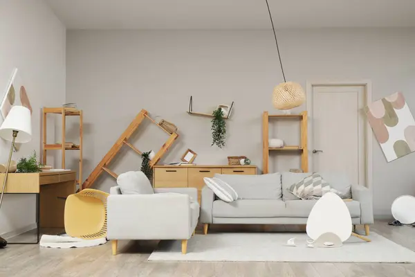 stock image Interior of messy living room with overturned furniture after earthquake