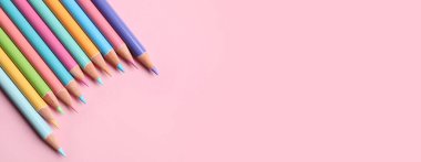 Pembe arkaplanda birçok renkli kalem ve metin için boşluk