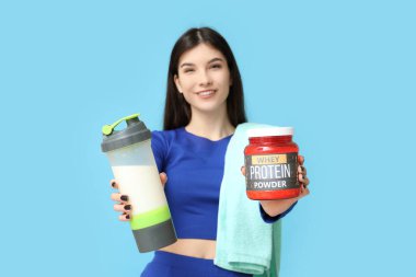 Arkaplanda protein karışımı, toz ve havlu olan genç bir kadın.