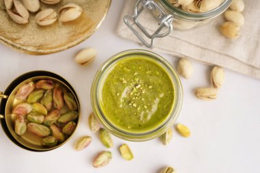 Fıstık ezmesi kavanozu ve beyaz arka planda ölçüm bardakları