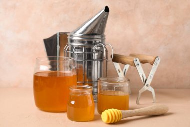 Kavanozlar dolusu tatlı bal ve bej masa üzerinde de kepçe.