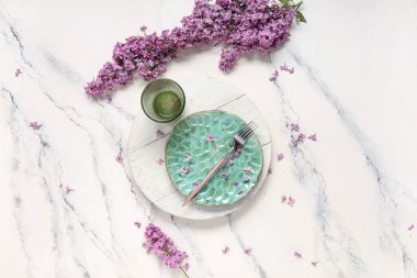 Beyaz grunge arkaplan üzerinde leylak çiçekleri ile güzel masa ayarları