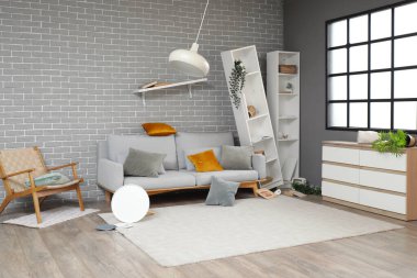 Interior of messy living room with overturned furniture after earthquake clipart