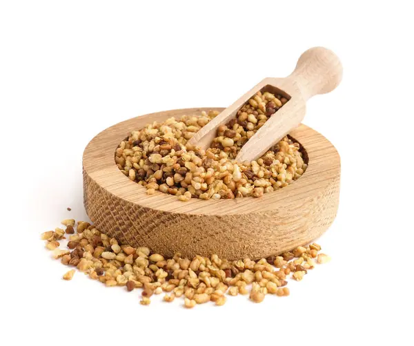 stock image Wooden bowl and scoop with raw buckwheat grains on white background