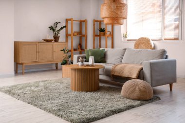 Masasında kanepe, çekmece ve Palo Santo olan bir oturma odası.