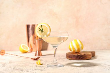 Hafif arkaplanda bir bardak martini ve limon.