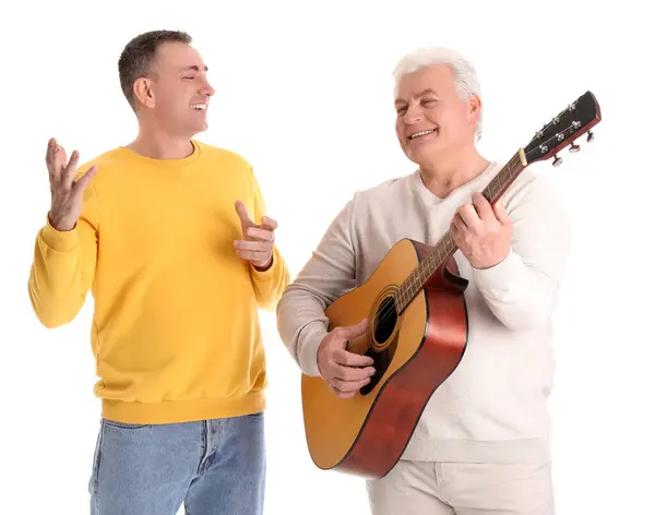 Stock image Mature brothers with guitar on white background