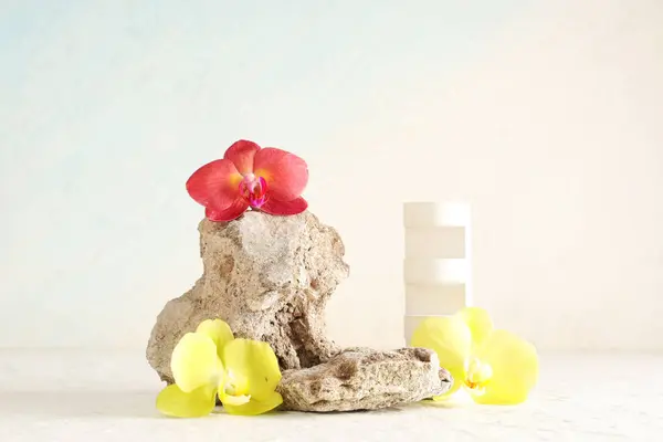 stock image Stones and decorative podium with beautiful orchid flowers on white background