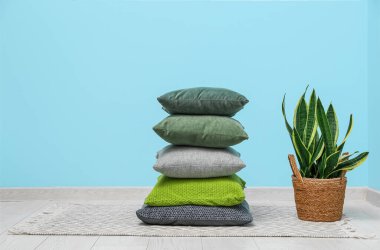 Yastıklar yere yığılır ve mavi duvarın yanına yerleştirilir.