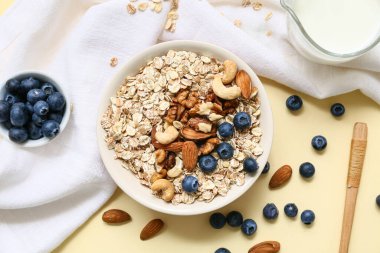 Peçete, fındık, çiğ yulaf ezmeli kase ve renkli böğürtlen, yakın plan.