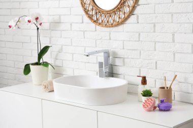 Banyo lavabosunun yanında saç derisi masaj aletleri.