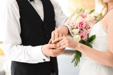 Yüzüklü genç çift düğün günlerinde çiçek reklamı veriyor, yakın plan.