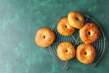 Yeşil arka planda lezzetli simitlerle durun.