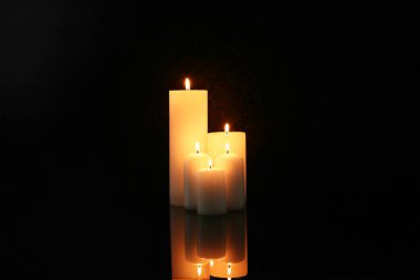 Burning candles on dark background. Day of Remembrance clipart