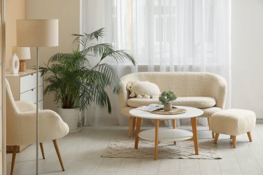 Oturma odasında rahat bir kanepe, koltuk ve sehpa var.