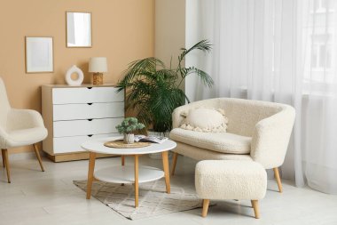 Oturma odasında rahat bir kanepe, koltuk ve sehpa var.