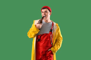 Yeşil arka planda biralı genç denizci.