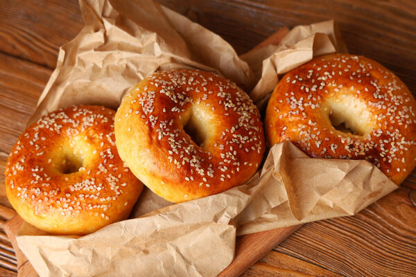Baking Paper Tasty Bagels Wooden Background — Stock Photo, Image