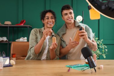 Couple of beauty bloggers with skincare products recording video at home