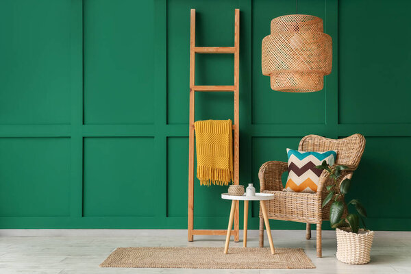 Interior of living room with wooden ladder, wicker armchair and table