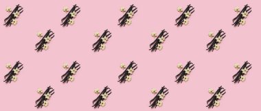 Many vanilla sticks on pink background. Pattern for design clipart