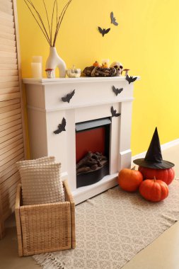 Interior of living room decorated for Halloween with fireplace and paper bats clipart