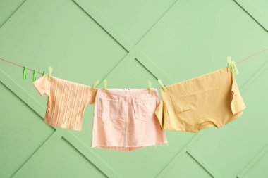 Temiz giysiler renkli duvarda asılı.