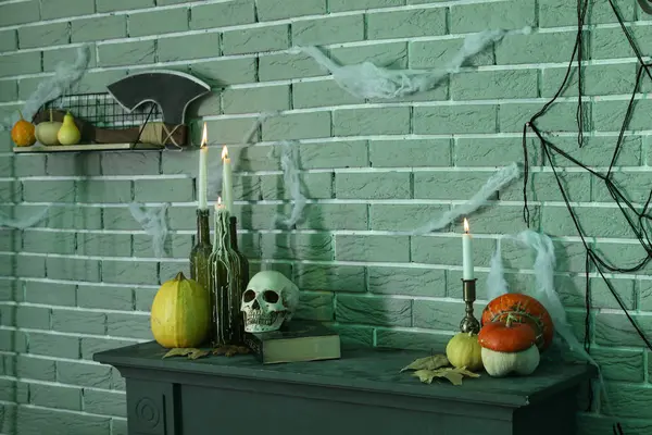 Balkabağıyla mum yakmak ve karanlık odada masanın üstünde Cadılar Bayramı dekoru