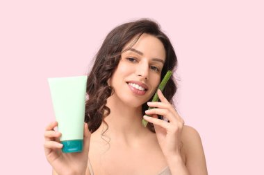 Aloe vera 'lı güzel genç bir kadın ve arka planda jöle.