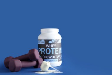 Bottle with protein powder, scoop and dumbbells on color background