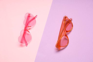 Renkli arkaplanda pembe güneş gözlüğü