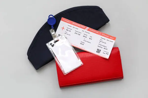 stock image Ticket, blank badge, wallet and stewardess hat on grey background