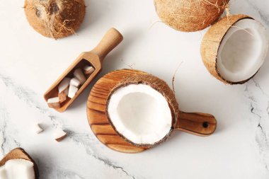 Tahta ve kepçeyle beyaz arka planda taze hindistan cevizi.