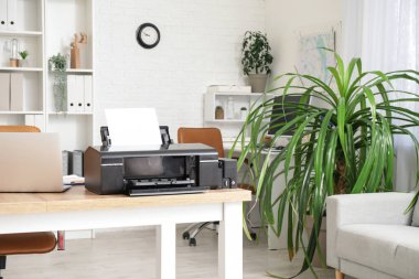 Modern yazıcı şık ofisteki ahşap masada.