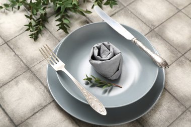 Gri fayanslı bitki dallarıyla güzel bir masa.