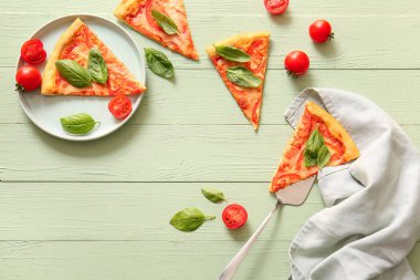 Yeşil ahşap arka planda lezzetli bir pizza margaritası.