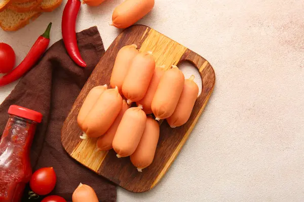 stock image Board of tasty boiled sausages on grey background