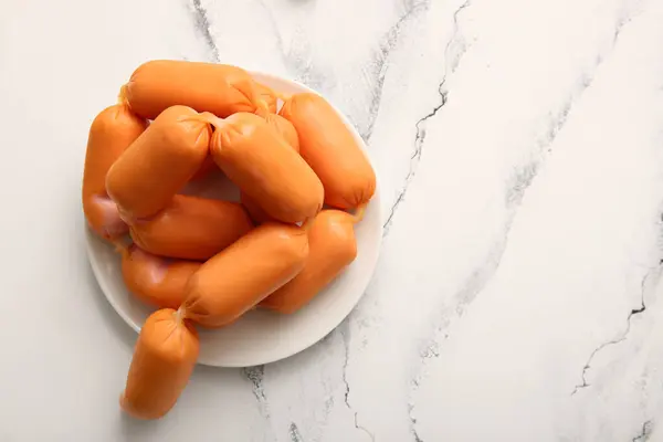 stock image Plate of tasty boiled sausages on white table