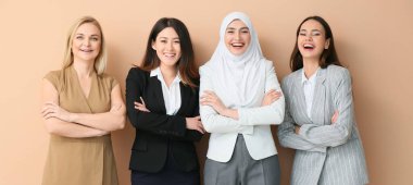 Beautiful businesswomen on beige background