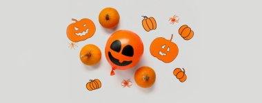 Işık arka planında balkabakları ve örümcekleri olan komik Cadılar Bayramı balonu