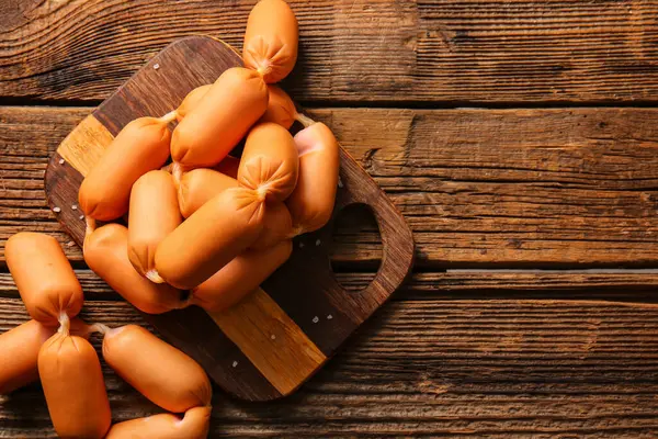 stock image Board of tasty boiled sausages on wooden background